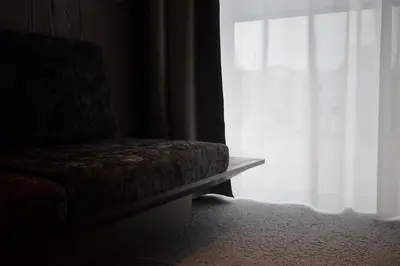 a chair sitting in front of a window at Hotel Rakuragu in Tokyo