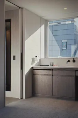 a bathroom with a sink and a large window at Hotel Rakuragu in Tokyo