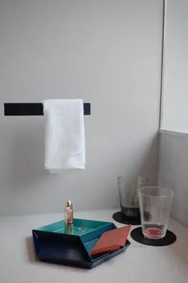 a table with a plate and two glasses and a towel at Hotel Rakuragu in Tokyo