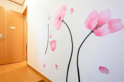 a room with pink flowers painted on the wall at Sky House BnB in Tokyo