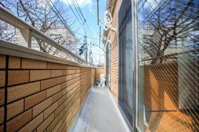 a hallway of a building with a glass wall at Sky House BnB in Tokyo