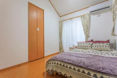 a bedroom with a large bed and a large window at Sky House BnB in Tokyo