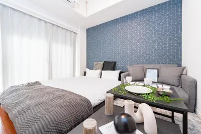 a bedroom with a bed and a table at Tokyo's best spot Shibuya! 3person room Free Wi-Fi in Tokyo