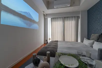a bedroom with a bed and a table with plates on it at Tokyo's best spot Shibuya! 3person room Free Wi-Fi in Tokyo