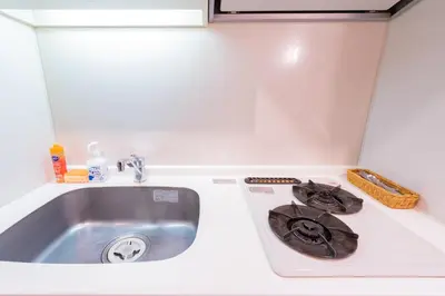 a kitchen counter with a sink and a stove at Tokyo's best spot Shibuya! 3person room Free Wi-Fi in Tokyo