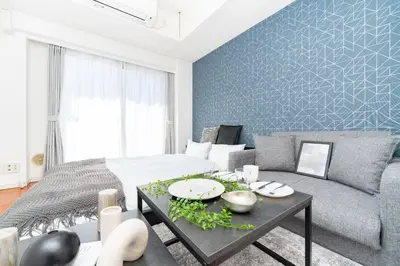 a living room with a bed and a couch at Tokyo's best spot Shibuya! 3person room Free Wi-Fi in Tokyo