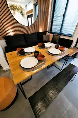 a wooden table with plates and bowls on top of it at Eden House in Tokyo