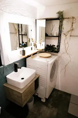 a bathroom with a sink and a washing machine at Eden House in Tokyo