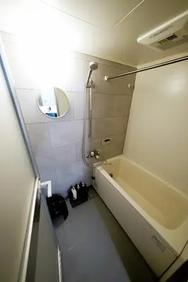 a bathroom with a bath tub and a sink at Eden House in Tokyo