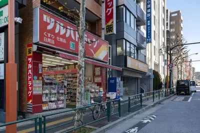 a street with many signs on buildings in a city at KISETSU\u65e9\u7a32\u7530l in Tokyo