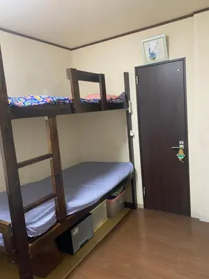 a room with two bunk beds and a door at \u65e5\u5149\u30d3\u30ebA or B in Tokyo