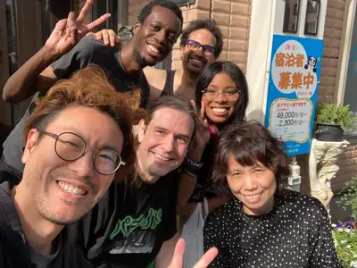 a group of people posing for a picture at \u65e5\u5149\u30d3\u30ebA or B in Tokyo