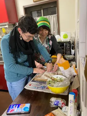 two women standing in a kitchen preparing food at \u65e5\u5149\u30d3\u30ebA or B in Tokyo