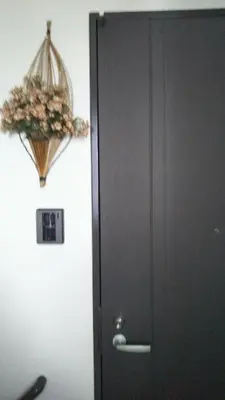 a door to a room with a flower basket on the wall at \u65e5\u5149\u30d3\u30ebA or B in Tokyo