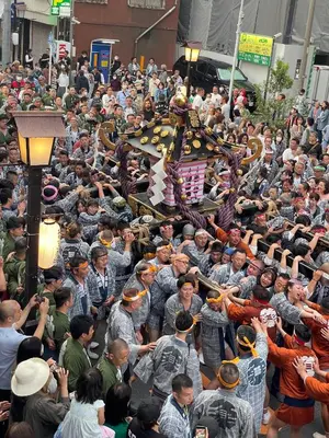 a crowd of people standing around in a parade at TenTen Guesthouse in Asakusa in Tokyo