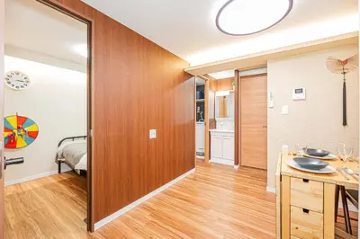 a hallway with a wooden door leading to a bedroom at Ueno Park Asakusa Temple Ueno Family Inn in Tokyo