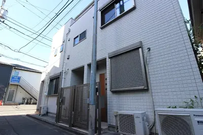 a white brick building with a door and windows at \u30a2\u30a4\u30ea\u30b9\u30b3\u30fc\u30c8 in Tokyo