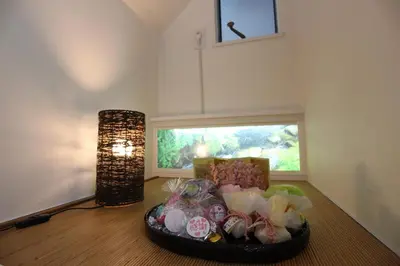 a table with a bowl of candies and a lamp at \u30a2\u30a4\u30ea\u30b9\u30b3\u30fc\u30c8 in Tokyo