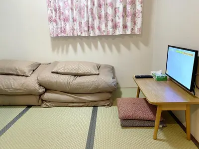 a living room with a couch and a table with a computer at \u548c\u7e01WAEN in Tokyo