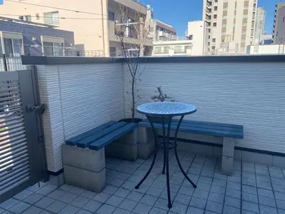 a table and a bench on a balcony at \u548c\u7e01WAEN in Tokyo