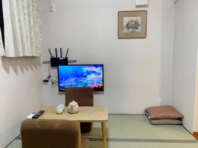 a living room with a table and a flat screen tv at \u548c\u7e01WAEN in Tokyo