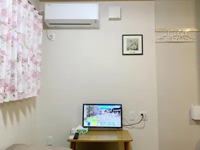 a laptop computer sitting on top of a wooden table at \u548c\u7e01WAEN in Tokyo