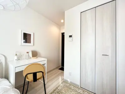 a bedroom with a desk and a chair next to a closet at TYO Ikebukuro Designer’s Apt 101 in Tokyo