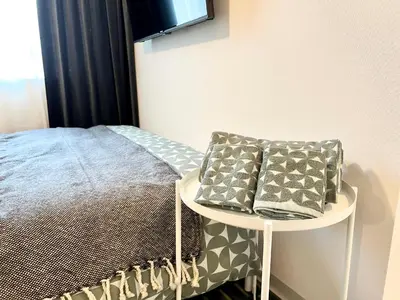 a bedroom with a bed and a table with pillows at TYO Ikebukuro Designer’s Apt 102 in Tokyo
