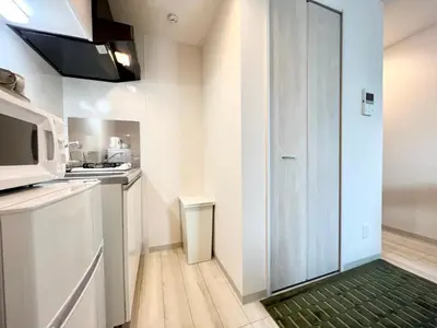 a kitchen with a green rug on the floor at TYO Ikebukuro Designer’s Apt 102 in Tokyo