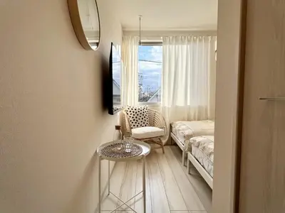 a living room with a couch and a table and a window at TYO Ikebukuro Designer’s Apt 103 in Tokyo