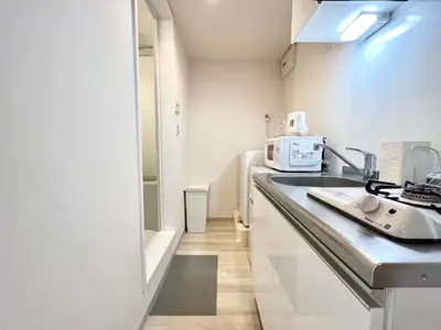 a kitchen with a sink and a microwave at TYO Ikebukuro Designer’s Apt 103 in Tokyo