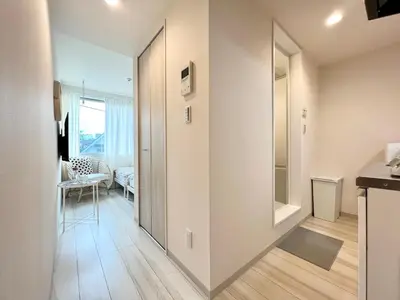 a hallway with a door leading to a living room at TYO Ikebukuro Designer’s Apt 103 in Tokyo