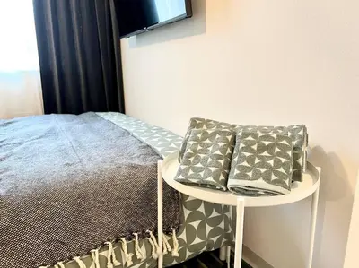 a bedroom with a bed and a table with pillows at TYO Ikebukuro Designer’s Apt 202 in Tokyo