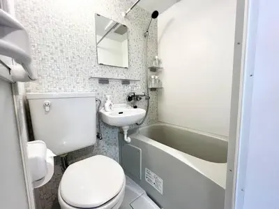 a bathroom with a toilet and a sink and a tub at TYO Ikebukuro Designer’s Apt 203 in Tokyo