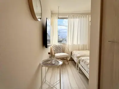 a living room with a couch and a table and a window at TYO Ikebukuro Designer’s Apt 203 in Tokyo