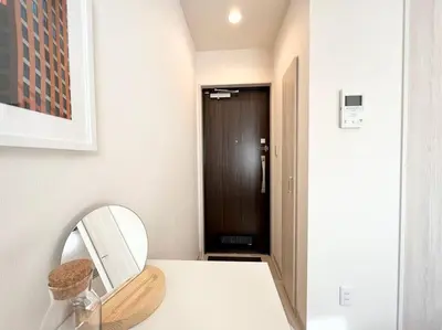 a bathroom with a mirror next to a door at TYO Ikebukuro Designer’s Apt 301 in Tokyo