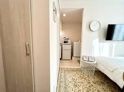 a room with a bedroom with a bed and a tv at TYO Ikebukuro Designer’s Apt 301 in Tokyo