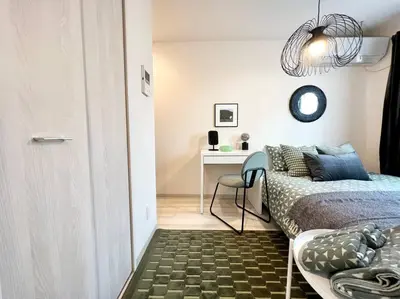 a bedroom with a bed and a desk with a chair at TYO Ikebukuro Designer’s Apt 302 in Tokyo
