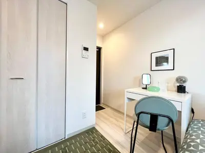 a bedroom with a bed and a desk and a chair at TYO Ikebukuro Designer’s Apt 302 in Tokyo