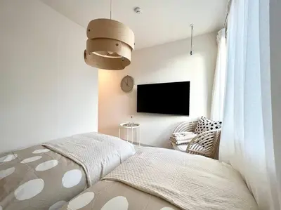 a bedroom with a bed and a flat screen tv at TYO Ikebukuro Designer’s Apt 303 in Tokyo