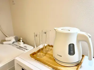 a white blender sitting on a cutting board on a counter at TYO Ikebukuro Designer’s Apt 303 in Tokyo
