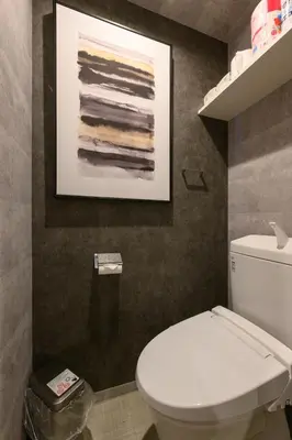 a bathroom with a toilet and a picture on the wall at RAKU Hotel Tokyo Bay Front in Tokyo