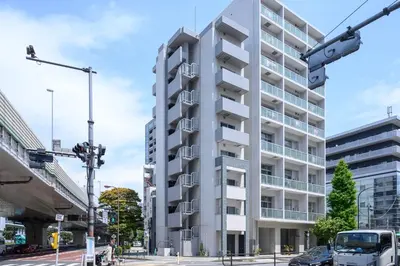 a tall white building on a city street at RAKU Hotel Tokyo Bay Front in Tokyo