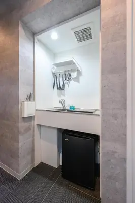 a kitchen with a counter and a sink in a room at RAKU Hotel Tokyo Bay Front in Tokyo