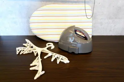 a hair dryer sitting on top of a wooden table at RAKU Hotel Tokyo Bay Front in Tokyo