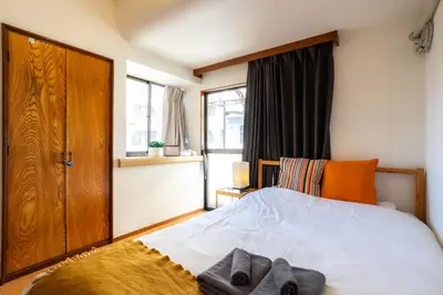 a bedroom with a bed with two towels on it at 3BR Entire House for7 #91Rated TraditionCozy Japanese Villa in Ikebukuro 6mins St in Tokyo