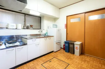 a kitchen with white cabinets and a refrigerator at 3BR Entire House for7 #91Rated TraditionCozy Japanese Villa in Ikebukuro 6mins St in Tokyo
