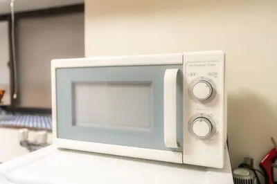 a microwave oven sitting on top of a counter at 3BR Entire House for7 #91Rated TraditionCozy Japanese Villa in Ikebukuro 6mins St in Tokyo