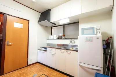 a kitchen with white cabinets and a refrigerator at 3BR Entire House for7 #91Rated TraditionCozy Japanese Villa in Ikebukuro 6mins St in Tokyo