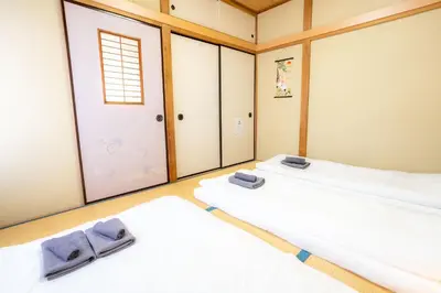 two beds in a room with two mirrors at 3BR Entire House for7 #91Rated TraditionCozy Japanese Villa in Ikebukuro 6mins St in Tokyo